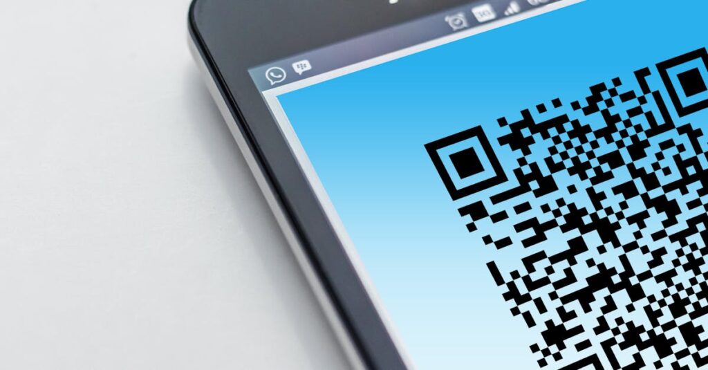 High-resolution close-up of a smartphone displaying a QR code on its screen.